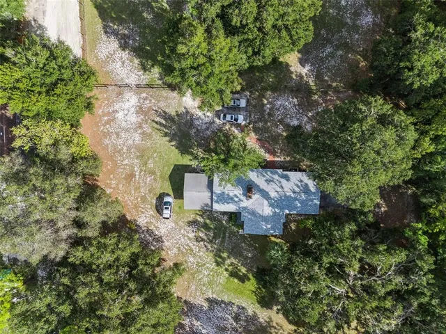 an aerial view of a house with a yard