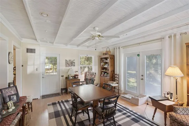 a view of a dining room with furniture and a chandelier