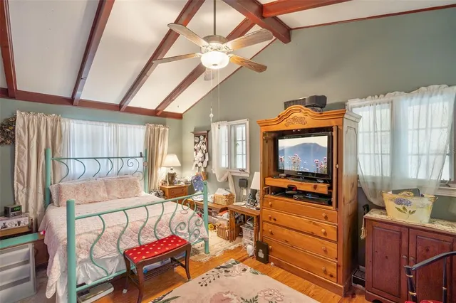 a living room with furniture a flat screen tv and a window