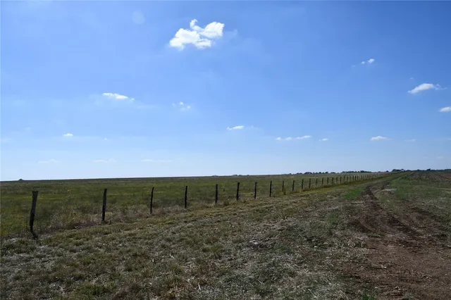 a view of a field with an ocean