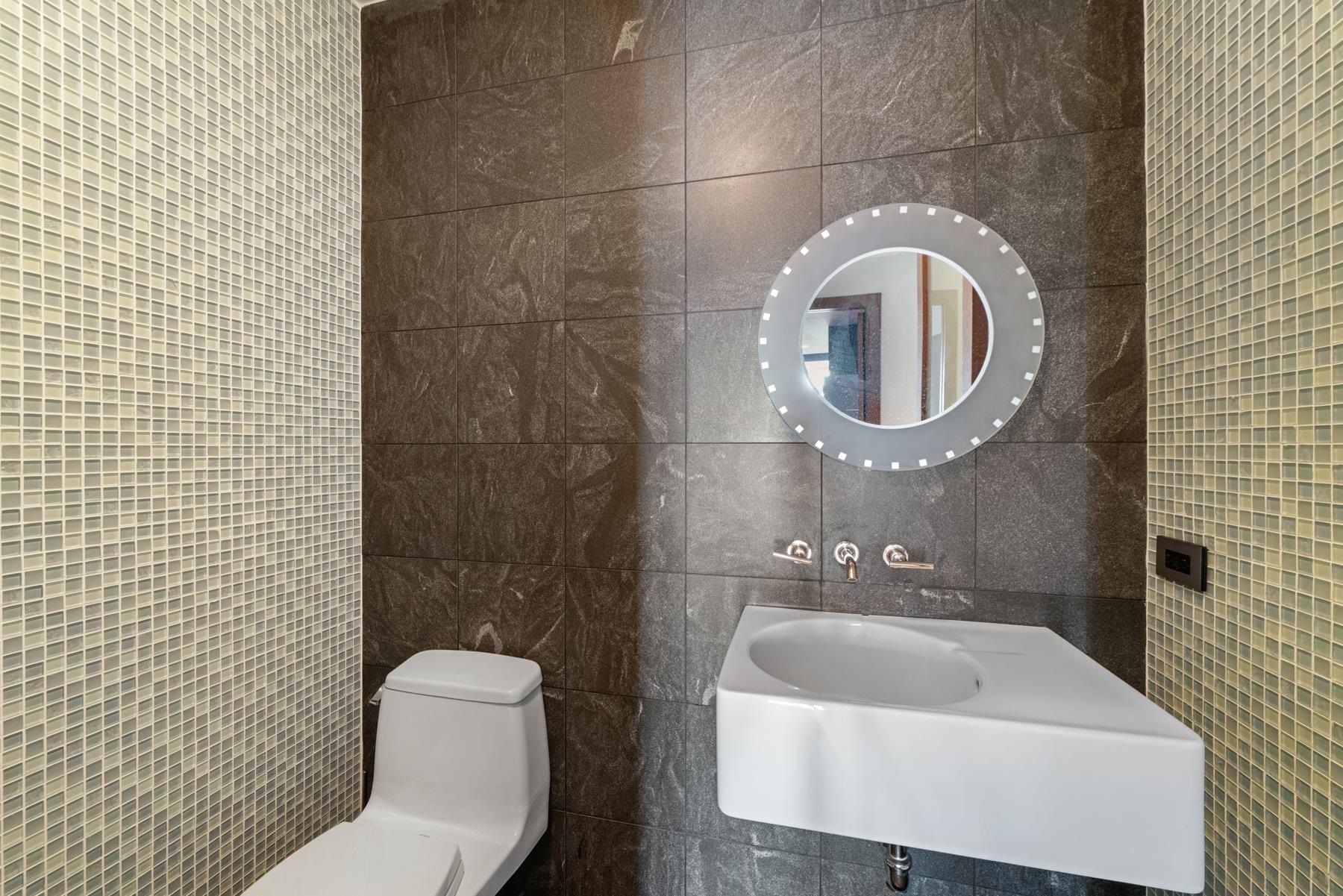 225 River Street, Unit 2003 Hoboken, NJ 07030 - Photo 13 of 19 a bathroom with a toilet a sink and mirror