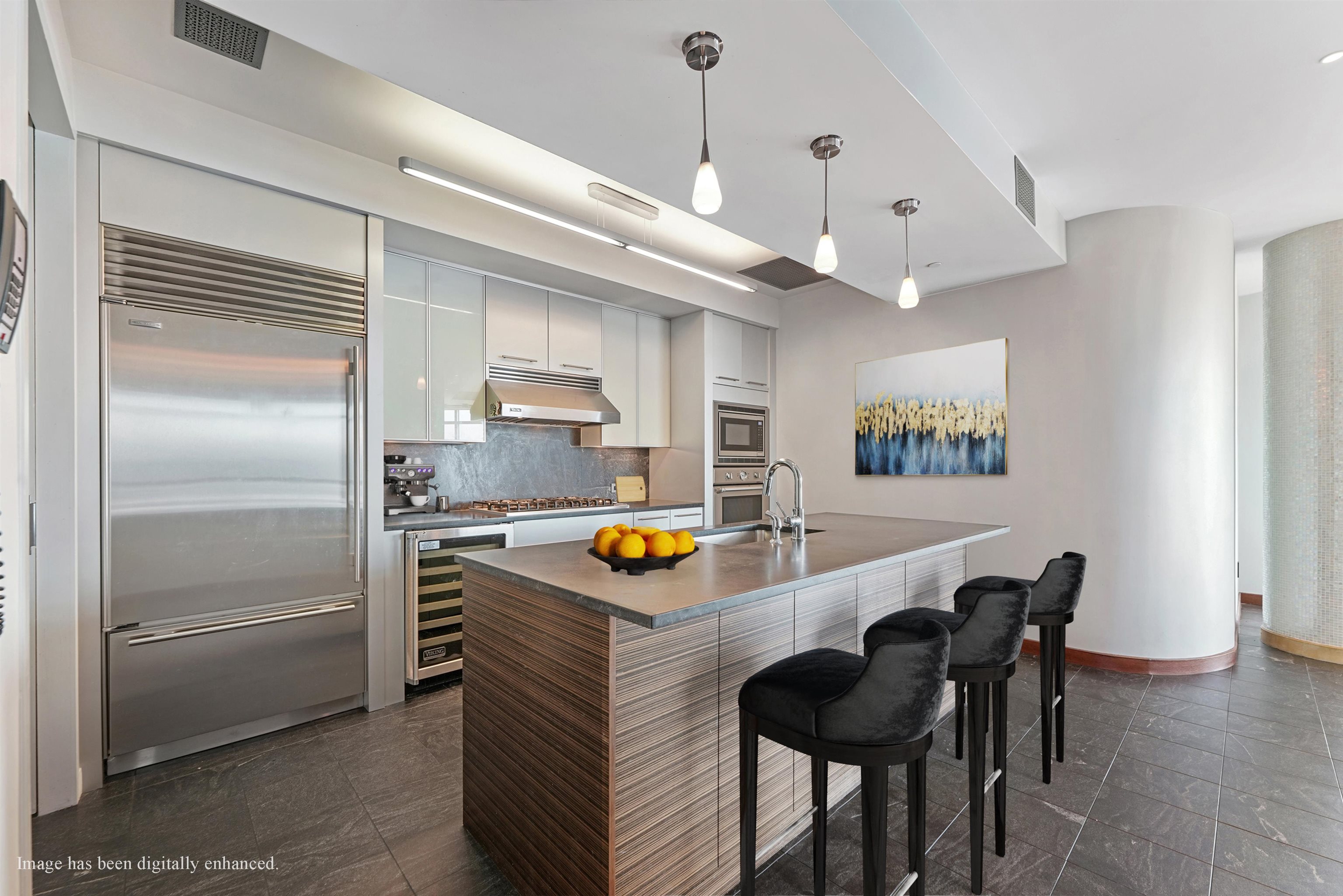 225 River Street, Unit 2003 Hoboken, NJ 07030 - Photo 5 of 19 a kitchen with stainless steel appliances granite countertop a table chairs and a refrigerator