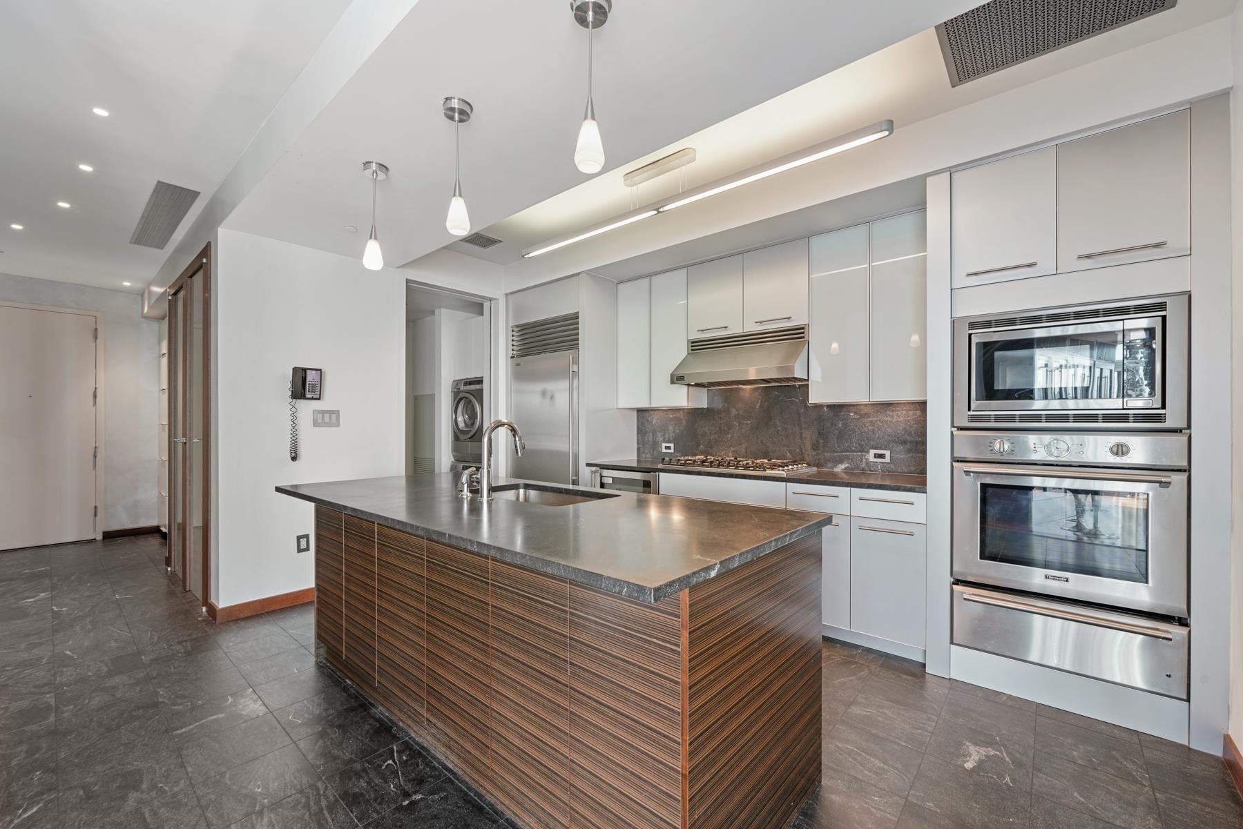 225 River Street, Unit 2003 Hoboken, NJ 07030 - Photo 6 of 19 a large kitchen with stainless steel appliances granite countertop a stove and a sink