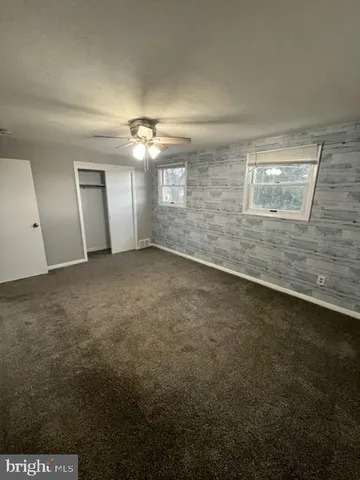 an empty room with a empty space and windows