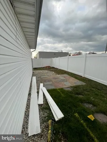 a view of a yard with large trees