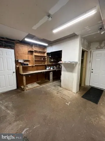 a view of kitchen with stainless steel appliances wooden floor and view living room