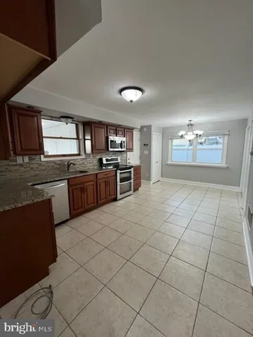 a large kitchen with cabinets and steel stainless steel appliances