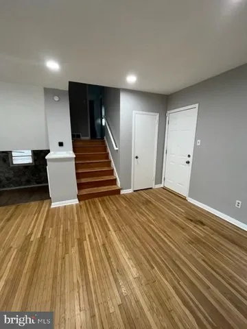 a view of a room with wooden floor and stairs