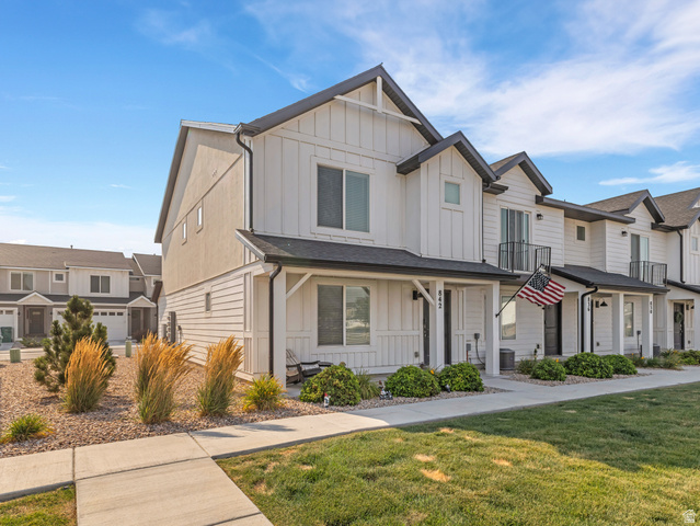842 North Old Rnch Road Lehi, UT 84048 - Photo 2 of 17 Contemporary townhome exterior featuring white board and batten siding, dark trim, and a covered front porch