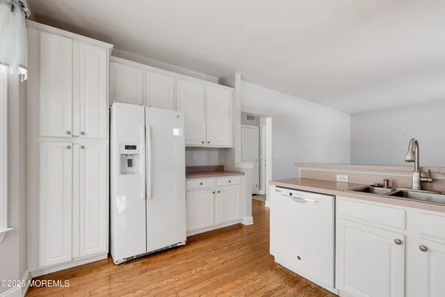 a kitchen with cabinets appliances and a window