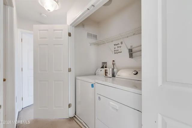 a utility room with cabinets washer and dryer