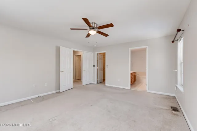 a view of a livingroom with a ceiling fan and window