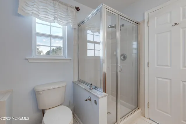 a bathroom with a toilet a sink and shower