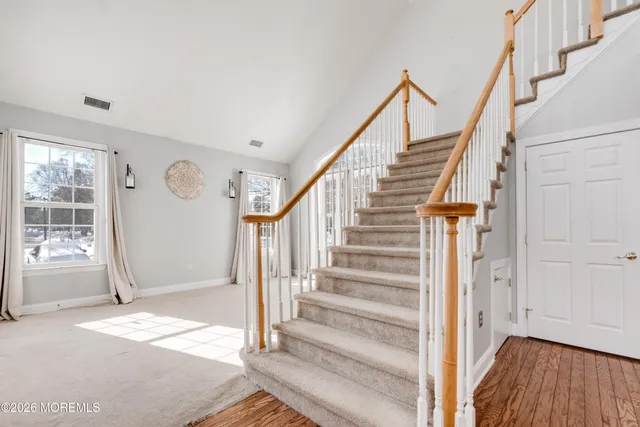 a view of entryway with wooden floor and stairs