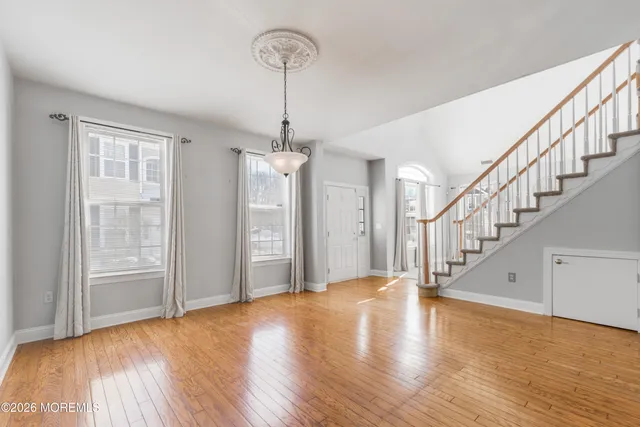 a view of entryway and hall with wooden floor
