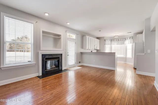 a view of a kitchen with wooden floor and a kitchen