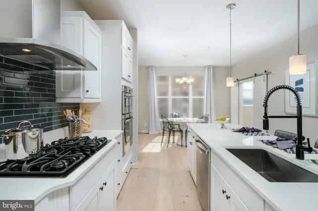 a kitchen with a sink stove and cabinets