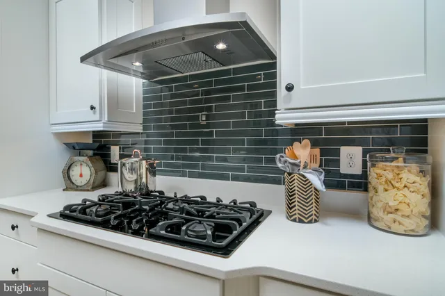 a kitchen with stove and cabinets
