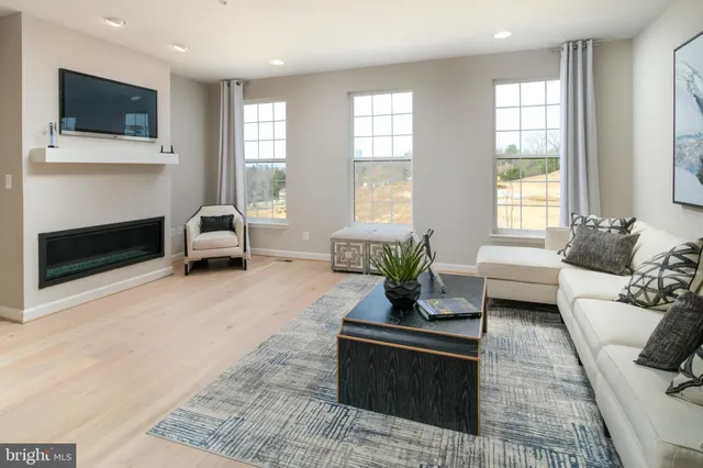 a living room with furniture fireplace and window