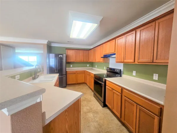 a kitchen with a sink a stove and cabinets