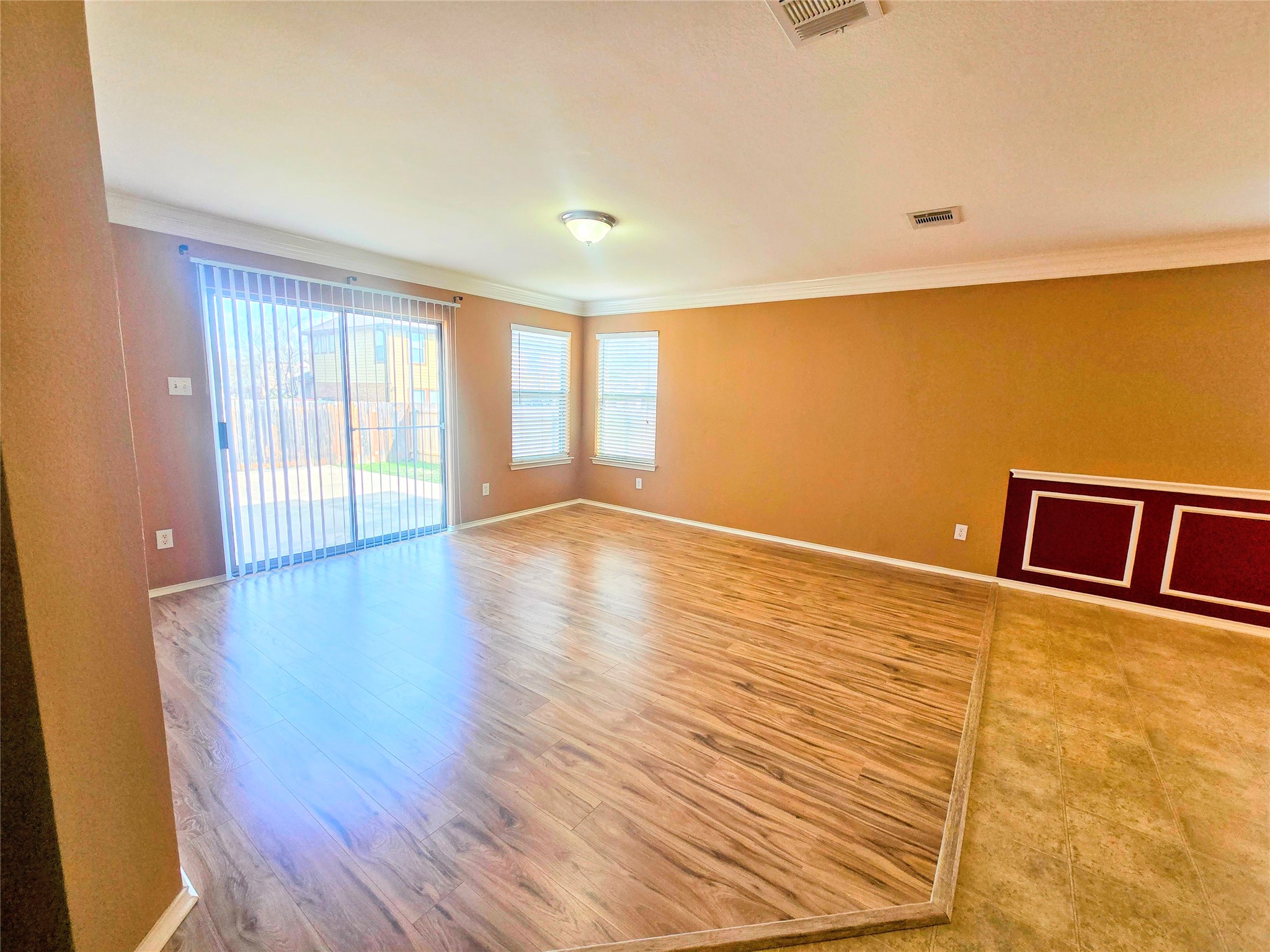 314 Ran Road Leander, TX 78641 - Photo 8 of 14 a view of an empty room with wooden floor and a window