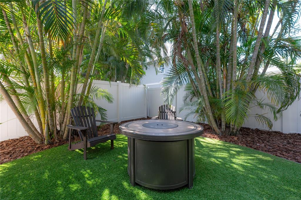 3108 West Villa Rosa Street Tampa, FL 33611 - Photo 53 of 58 a view of a backyard with table and chairs potted plants and large tree
