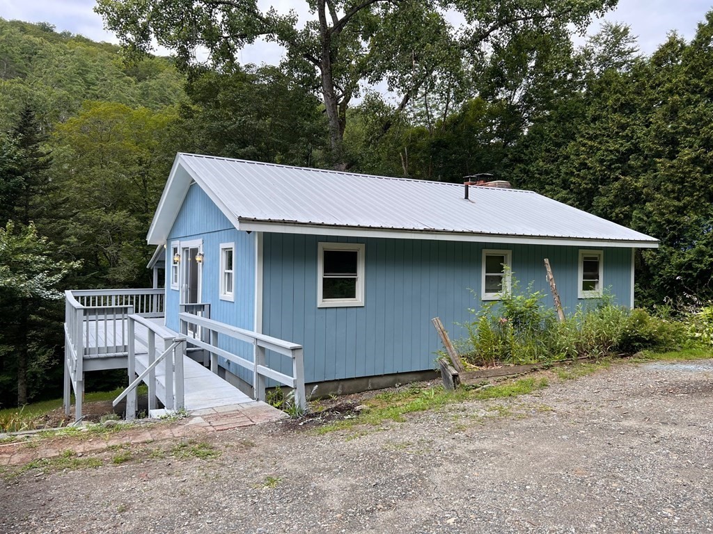 a view of a house with a yard and sitting area