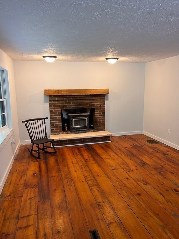 2 Cider Mill Lane Colrain, MA 01340 - Photo 14 of 32 a view of empty room with wooden floor and fireplace