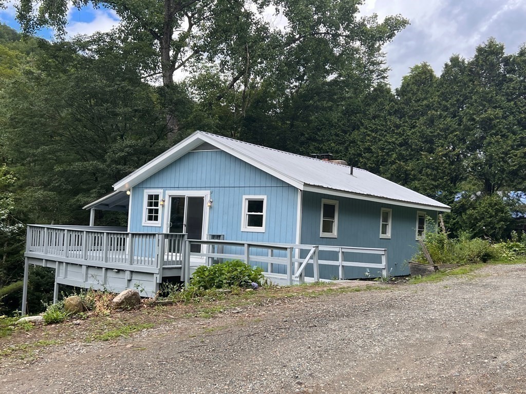 2 Cider Mill Lane Colrain, MA 01340 - Photo 5 of 32 a front view of house with yard and trees in the background