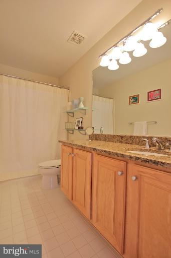 7335 Hampton Manor Place Springfield, VA 22150 - Photo 3 of 22 a bathroom with a granite countertop sink and a mirror
