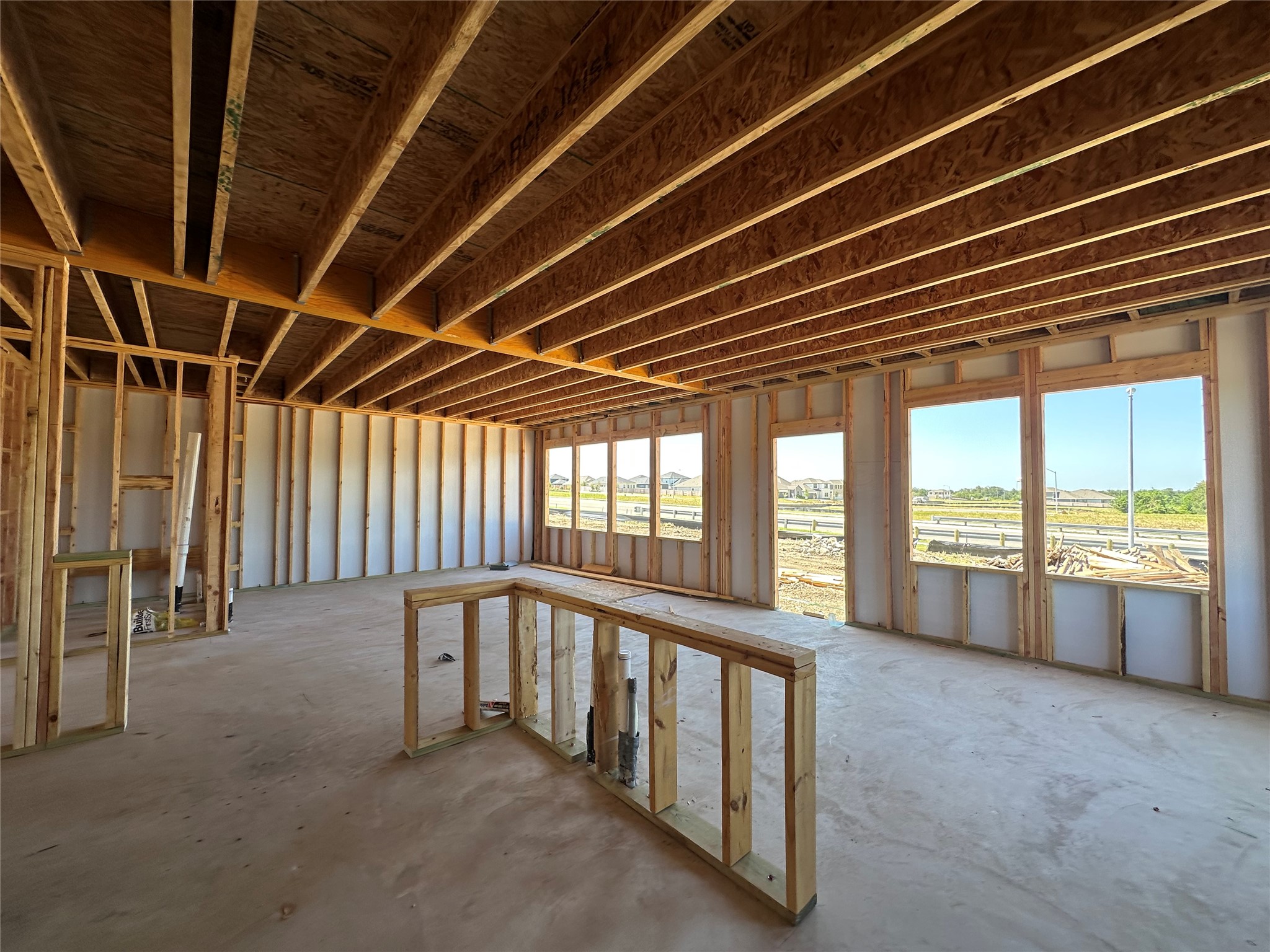 25517 Flora Bella Lane Elgin, TX 78621 - Photo 3 of 33 Framed walls and ceiling joists await finishing touches in this new construction.