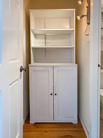 a view of walk in closet with empty racks