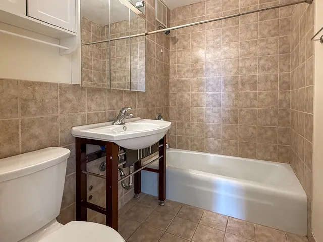 a bathroom with a sink a toilet and bathtub