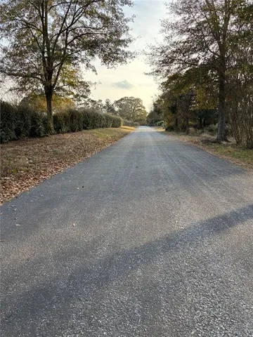 a view of a field with trees in background