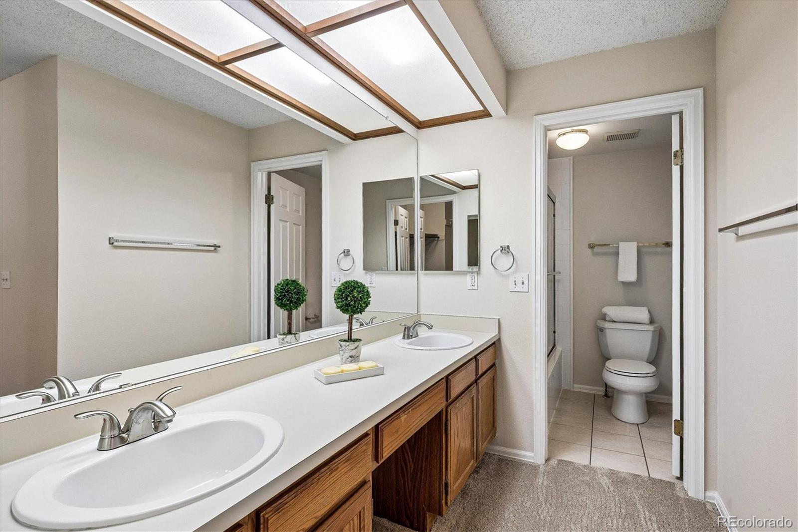 8624 Redstone Street Highlands Ranch, CO 80126 - Photo 13 of 26 a bathroom with a sink double vanity and a toilet