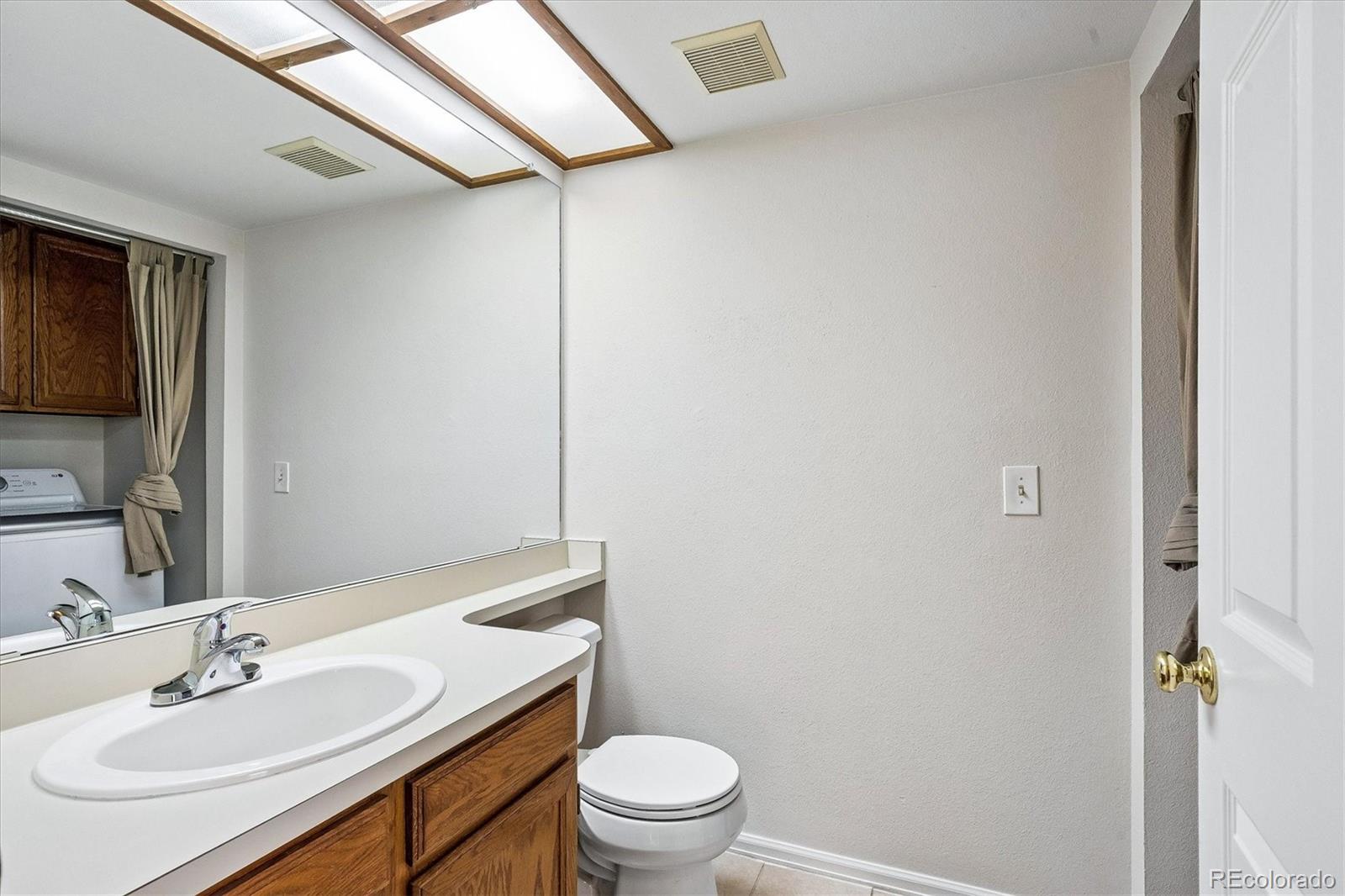 8624 Redstone Street Highlands Ranch, CO 80126 - Photo 15 of 26 a bathroom with a sink toilet vanity and shower