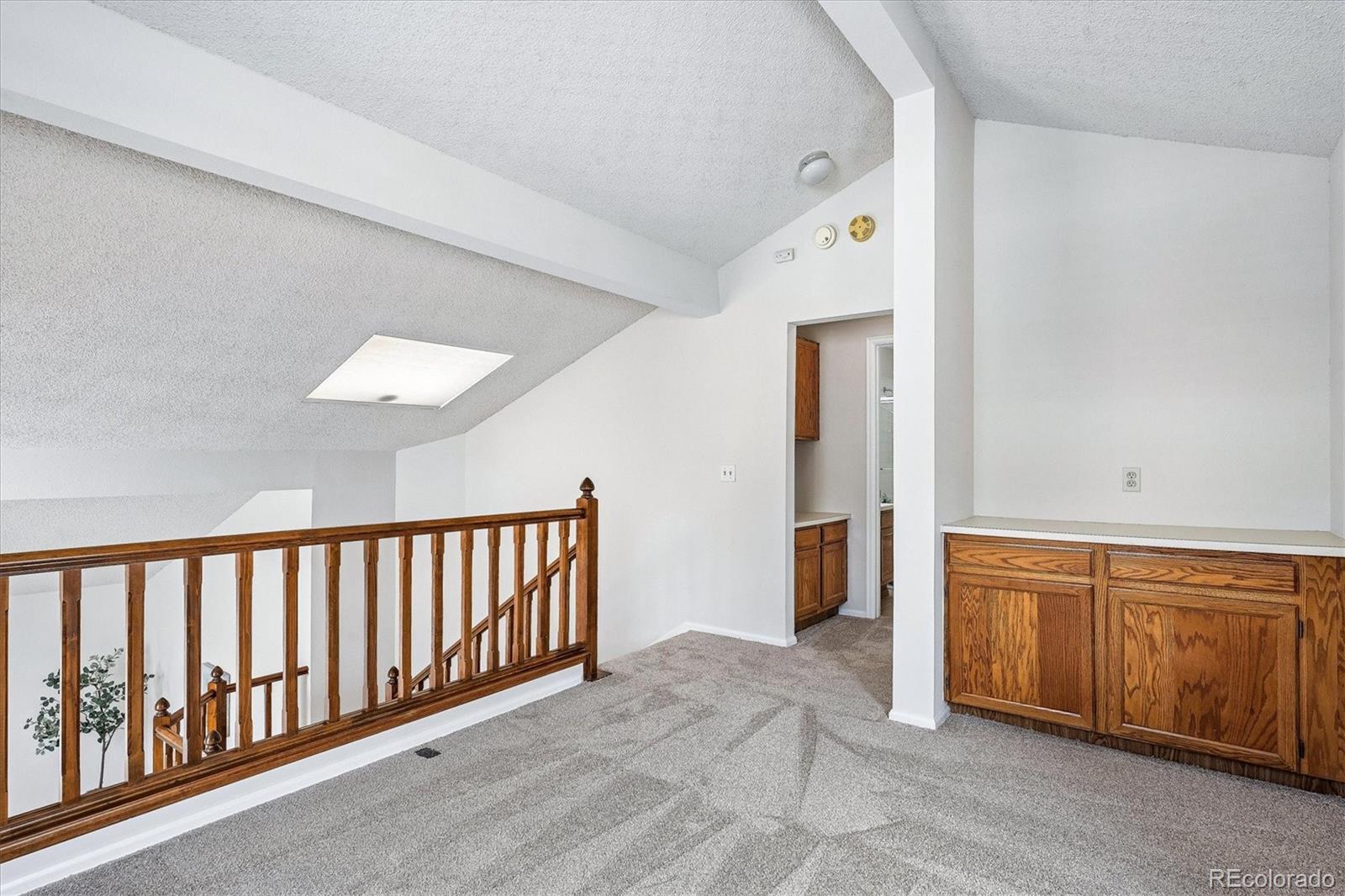8624 Redstone Street Highlands Ranch, CO 80126 - Photo 18 of 26 a view of a hallway with entryway wooden floor and front door