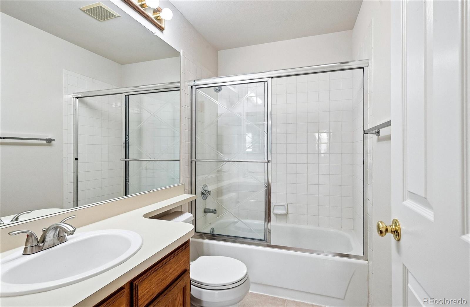 8624 Redstone Street Highlands Ranch, CO 80126 - Photo 20 of 26 a bathroom with a sink toilet and shower
