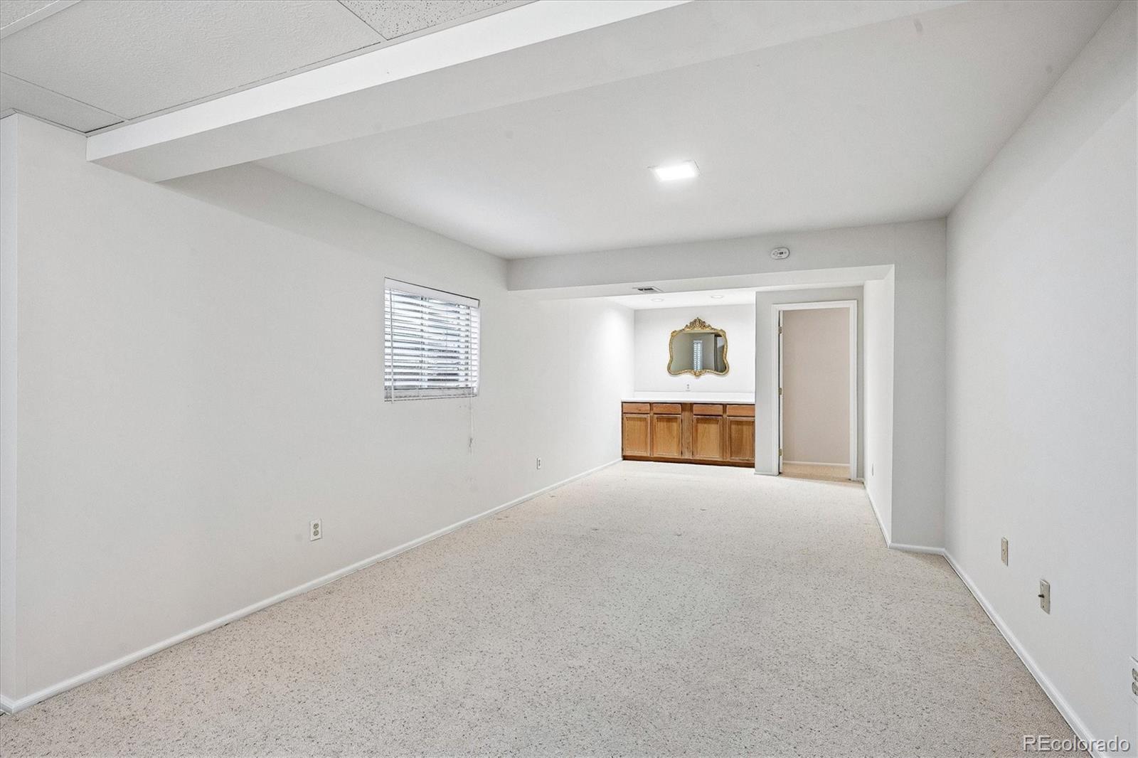 8624 Redstone Street Highlands Ranch, CO 80126 - Photo 21 of 26 an empty room with windows and cabinet