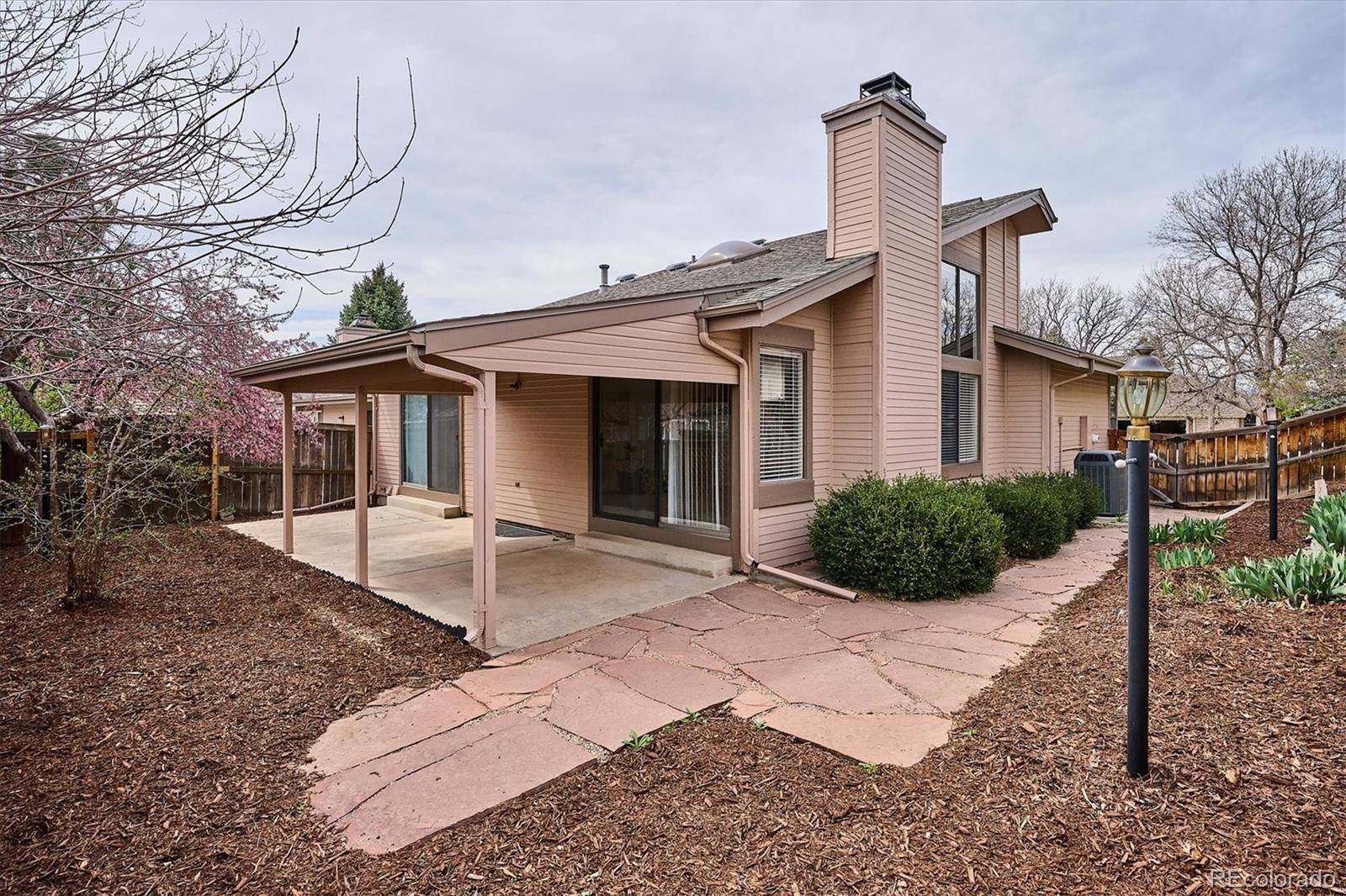 8624 Redstone Street Highlands Ranch, CO 80126 - Photo 26 of 26 a front view of a house with garden