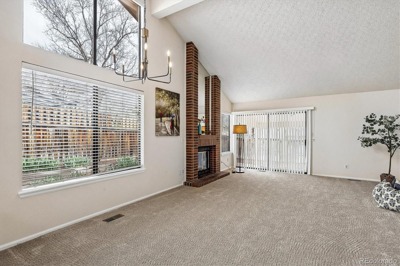 8624 Redstone Street Highlands Ranch, CO 80126 - Photo 4 of 26 a view of an empty room with a window and fireplace
