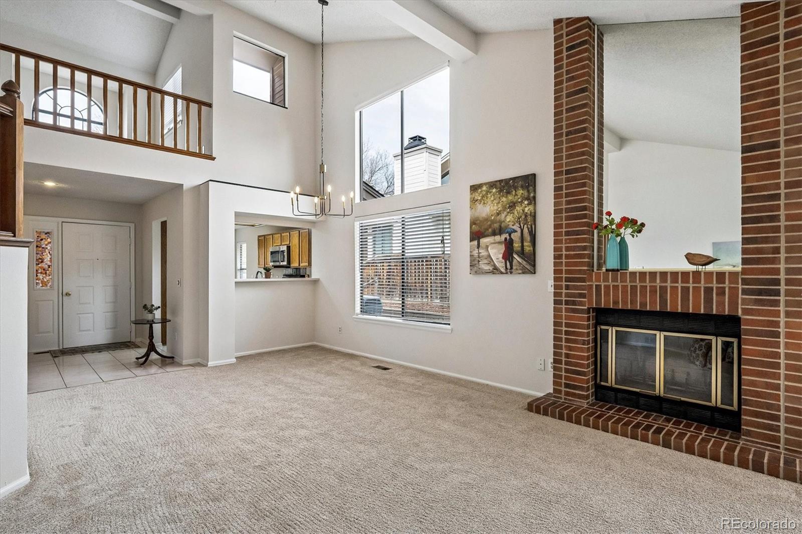 8624 Redstone Street Highlands Ranch, CO 80126 - Photo 7 of 26 a view of an empty room with fireplace and windows