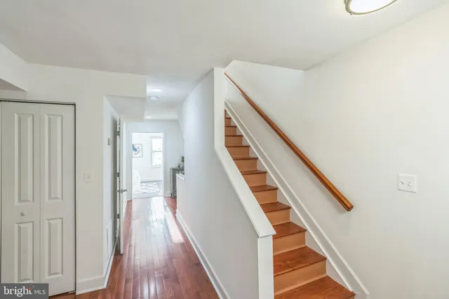 a bedroom with a bed and a table in it with window