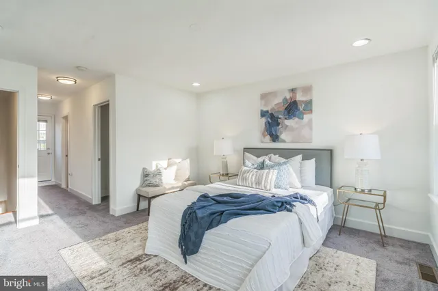 a bedroom with a bed and a dresser