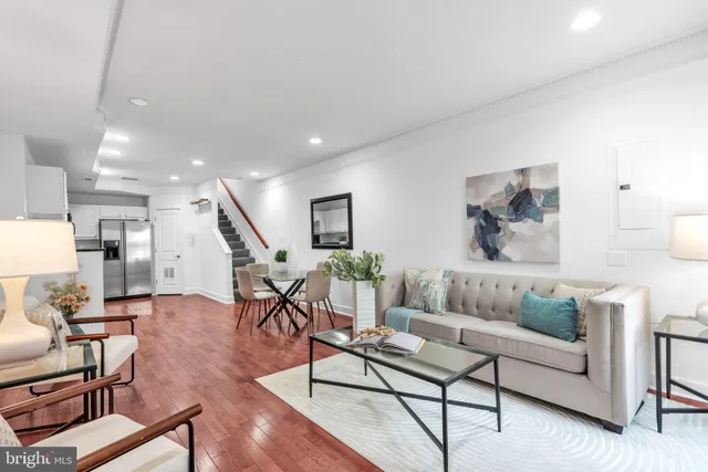 a living room with furniture and wooden floor