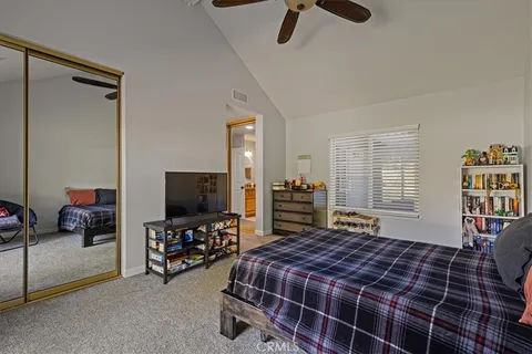 a bedroom with bed and tv