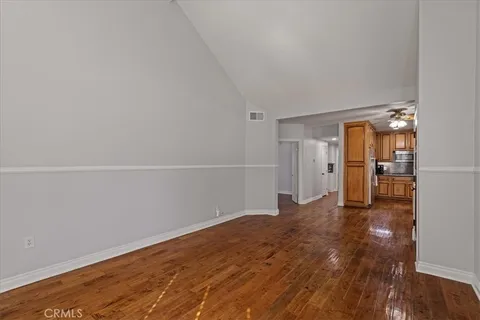 a view of empty room with wooden floor