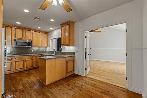 a kitchen with granite countertop a refrigerator and a sink