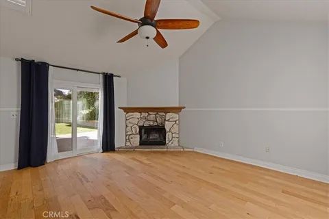 an empty room with windows and fireplace