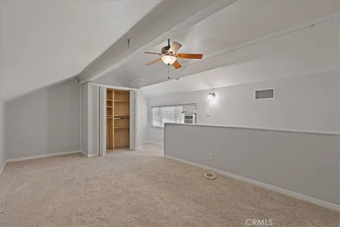 a view of a livingroom with a ceiling fan and window
